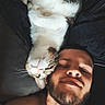 cat, man, selfie, indoor, relaxed, lying_down, shirtless, pet, animal, beard, closeup, companion, feline, resting, casual, portrait, friendship, cozy, couch, happy