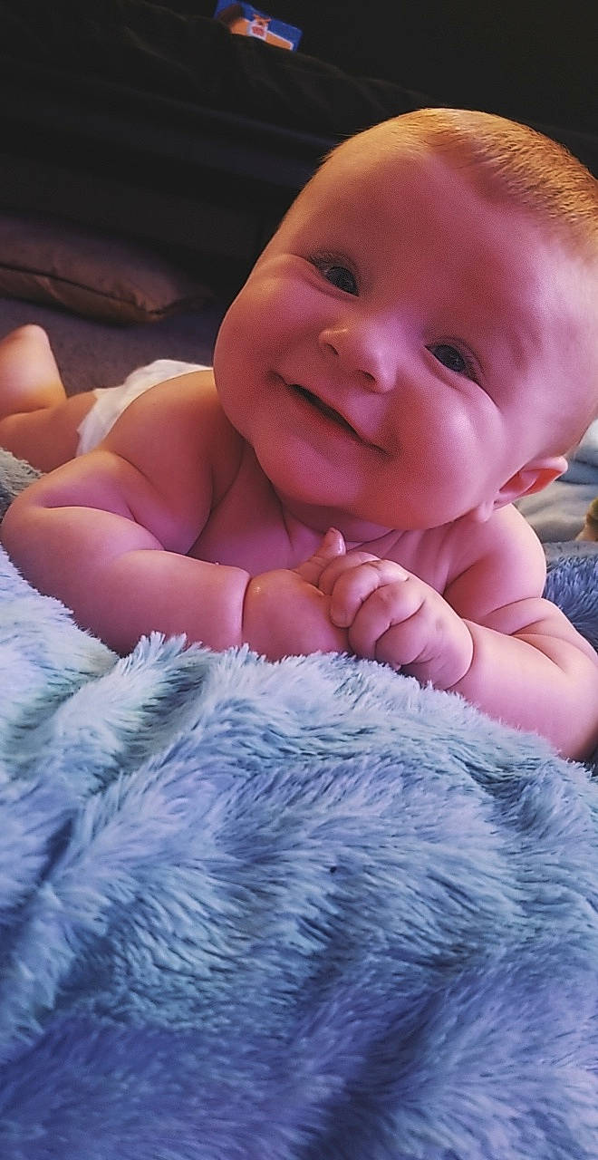 Tomas is registered to the contest to win money with this photo: baby, baby_toddler_clothing, beauty, cheek, comfort, eye, face, finger, gesture, happy, head, iris, joy, lip, nose, person, pink, skin, smile, thumb