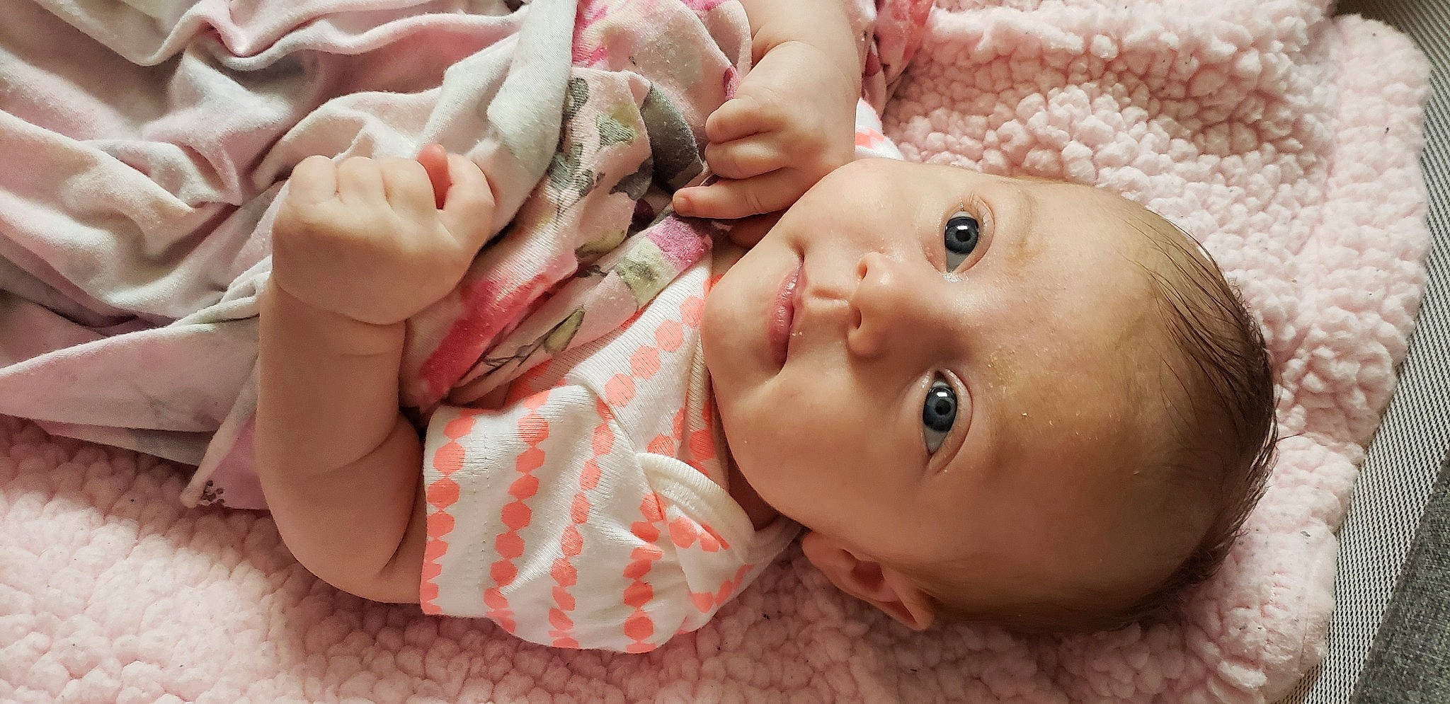 Antonina is registered to the contest to win money with this photo: baby, baby_toddler_clothing, cheek, chin, eye, eyebrow, eyelash, face, facial_expression, finger, gesture, hand, head, human_body, lip, mouth, nose, person, pink, skin