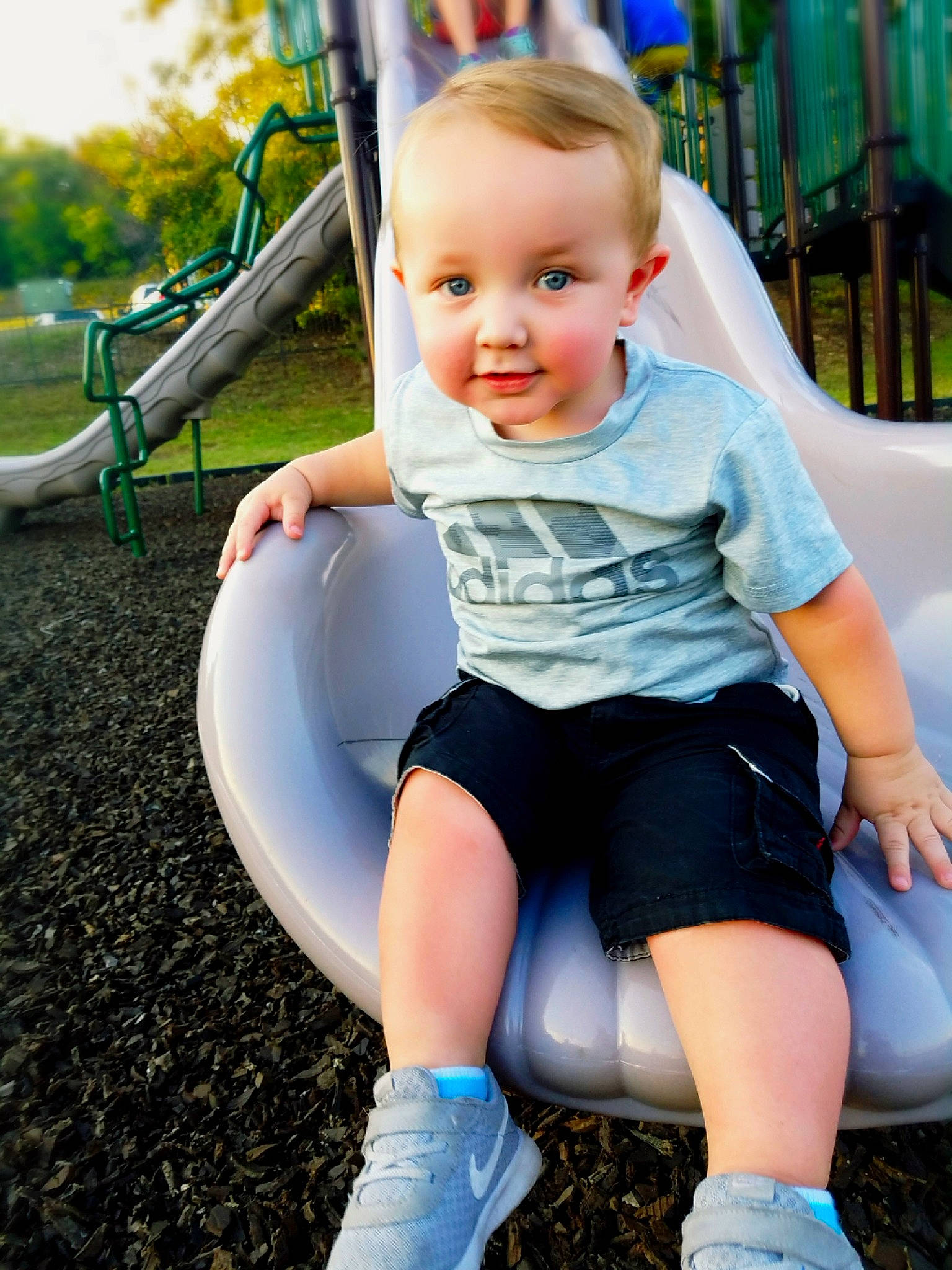 Titan is registered to the contest to win money with this photo: abdomen, baby_products, blond, blue, child, day, facial_expression, fun, girl, happiness, human_hair_color, infant, jeans, leg, person, play, sitting, skin, smile, standing
