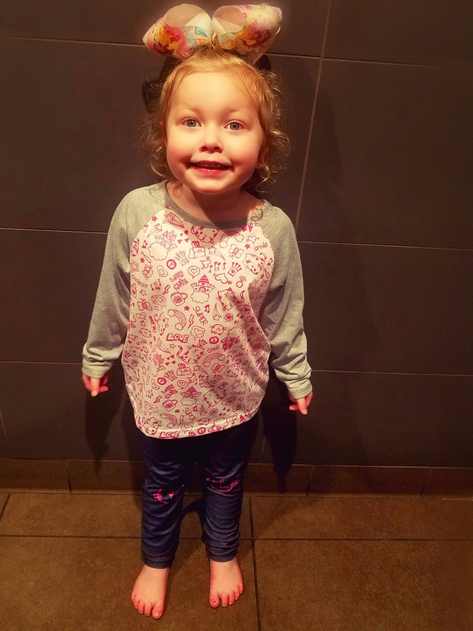 Larissa is registered to the contest to win money with this photo: child, clothing, day, design, fun, girl, hair_accessory, headgear, joint, joy, outerwear, pattern, person, pink, shoulder, skin, sleeve, standing, t_shirt, textile