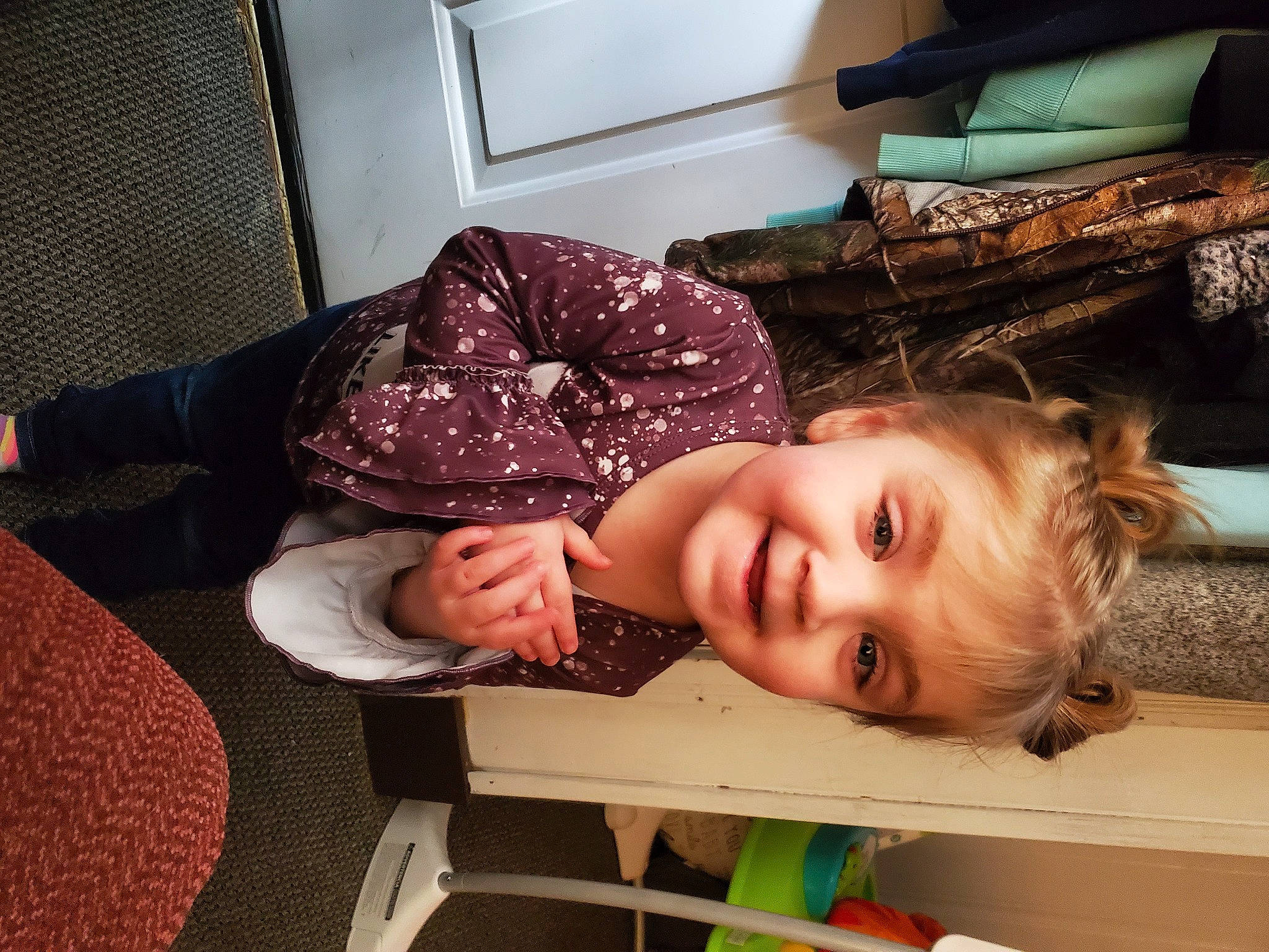 Lila is registered to the contest to win money with this photo: baby_toddler_clothing, cheek, child, comfort, flooring, fun, hairstyle, happy, joy, mouth, person, picture_frame, room, sitting, smile, toddler, vacation, wood