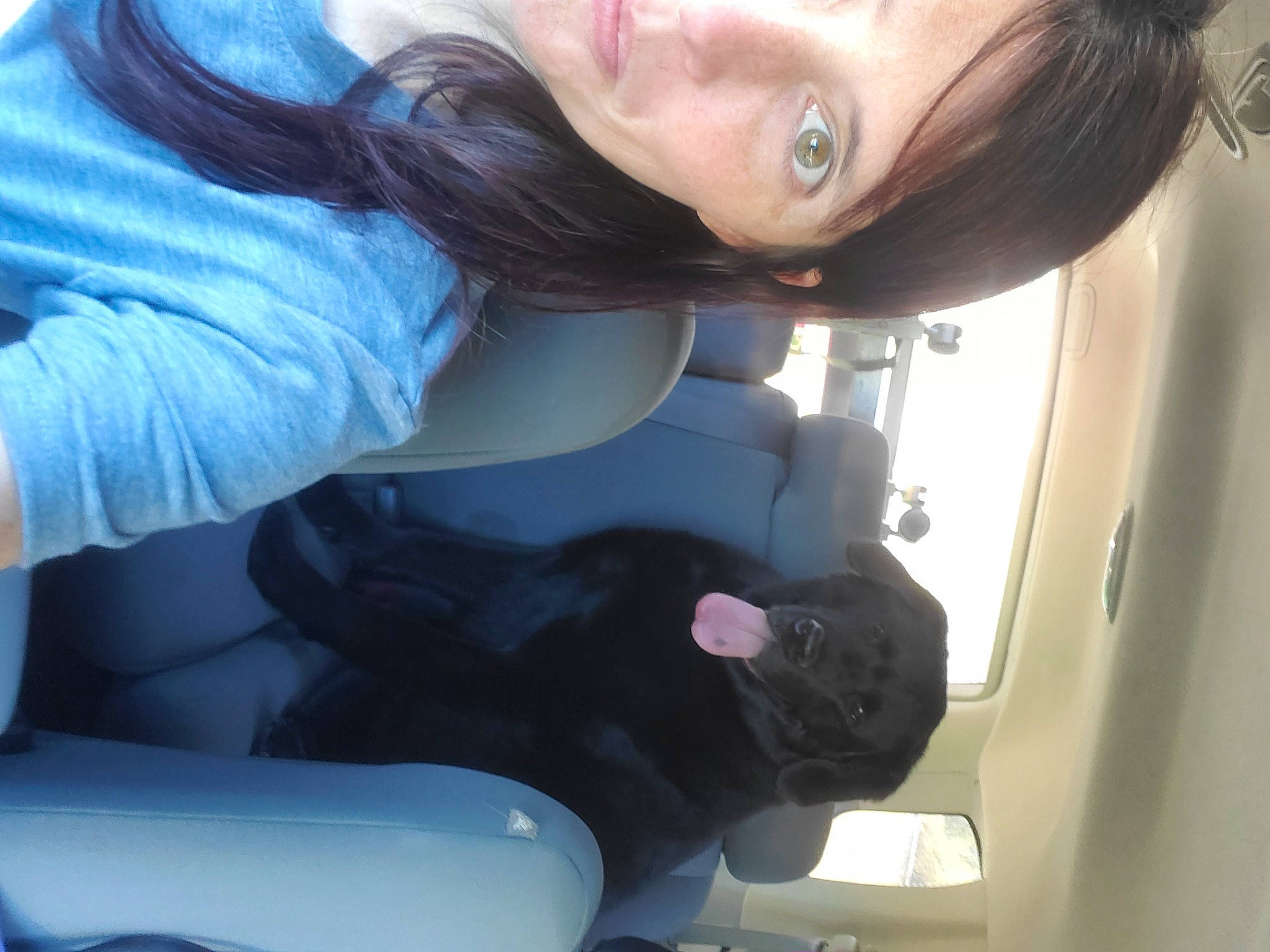 Chewie is registered to the contest to win money with this photo: auto_part, black_hair, car_seat, comfort, elbow, eyebrow, eyelash, eyewear, fun, gesture, hair, light, long_hair, motor_vehicle, mouth, nail, neck, skin, vehicle_door, window