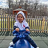 toddler, child, playground, spring_rider, hoodie, white_shoes, outdoor, fence, gazebo, trees, smile, happy, toy, recreation, casual_clothing, daylight, grass, park, blue, person
