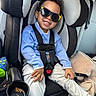 Zidane joined the competition — help win amazing prizes! child, toddler, car_seat, sunglasses, smile, blue_sweater, white_pants, car_interior, seatbelt, curly_hair, happy, safety, cup_holder, blanket, casual_clothing, portrait, young_child, cute, travel, fun