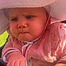 adorable, baby, blue_eyes, candid, chubby_cheeks, closeup, expression, face, grip, hands, hat_brim, infant, outdoors, pink_clothing, portrait, pout, stroller, sunhat, sunlight, white_hat