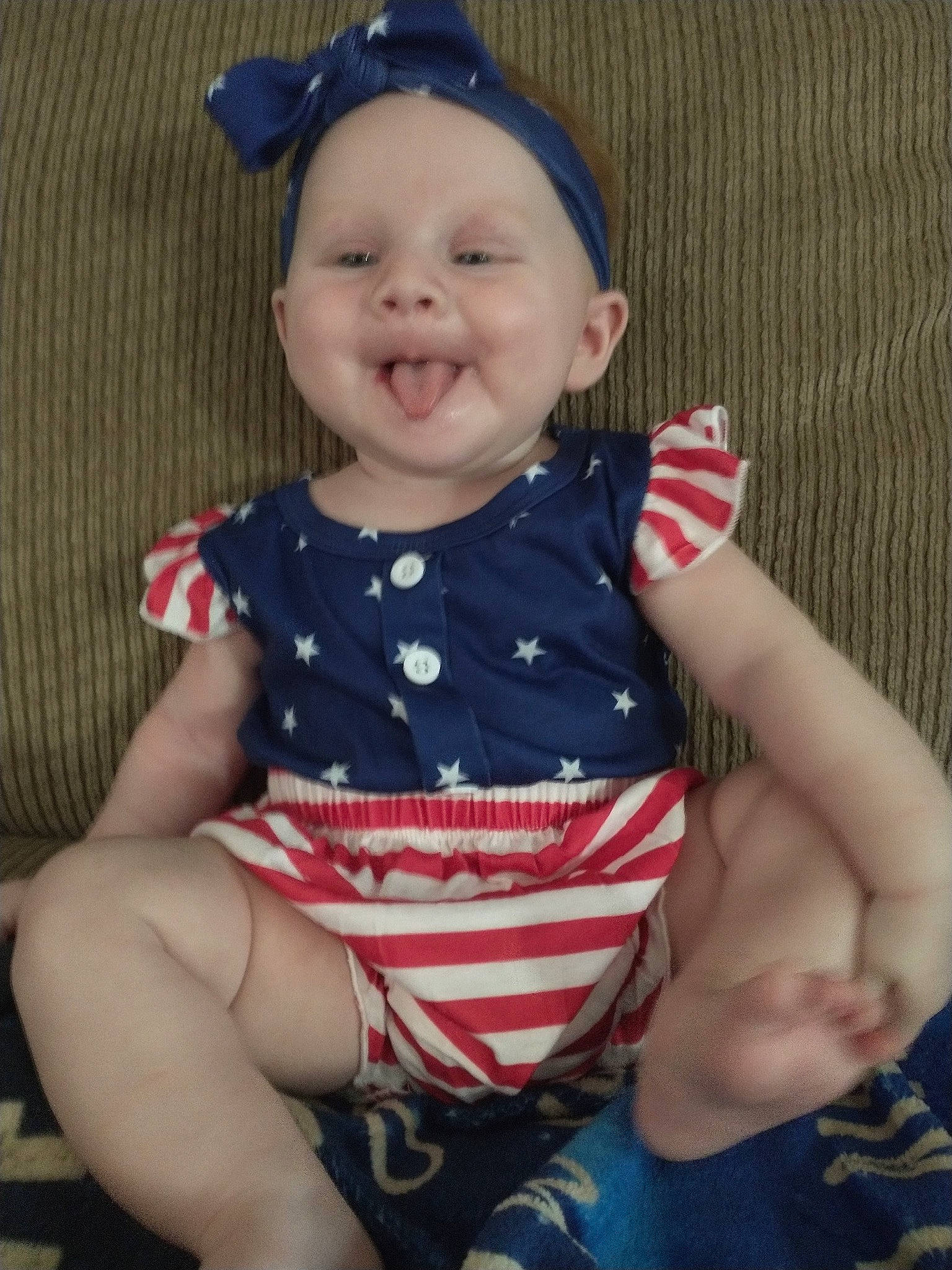 Magnolia is registered to the contest to win money with this photo: baby, baby_toddler_clothing, blue, cheek, cool, dress, eye, finger, happy, head, human_leg, lip, organ, pattern, person, sleeve, smile, t_shirt, textile, thigh