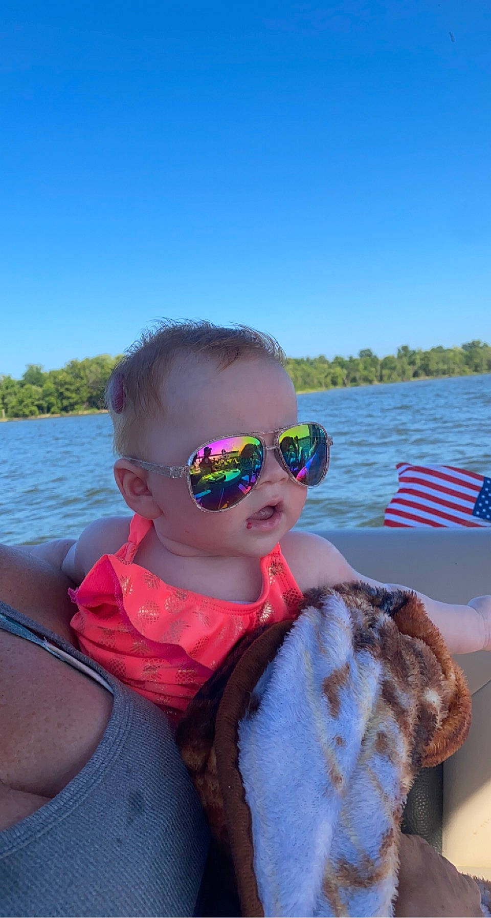 Magnolia is registered to the contest to win money with this photo: baby_toddler_clothing, cool, eyewear, face, fun, goggles, happy, lake, leisure, lifejacket, person, personal_protective_equipment, recreation, sky, summer, sunglasses, toddler, travel, tree, vision_care