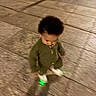 Zamond joined the competition — help win amazing prizes! child, toddler, curly_hair, green_clothing, white_shoes, glowing_shoes, sidewalk, pavement, outdoor, night, traffic_cone, street, walking, motion_blur, person, urban, casual_clothing, young_child, looking_down, shadow