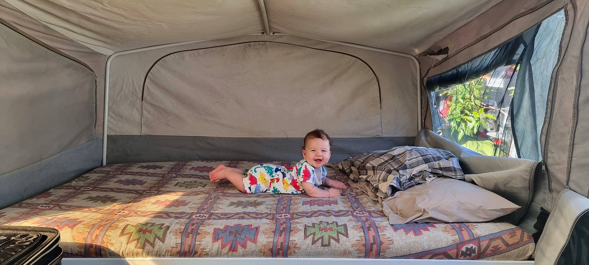 Joey joined the competition — help win amazing prizes! automotive_exterior, baby, car_seat, child, comfort, family_car, fun, grass, joy, leisure, linens, pattern, person, plant, recreation, shade, sitting, tent, tints_and_shades, toddler