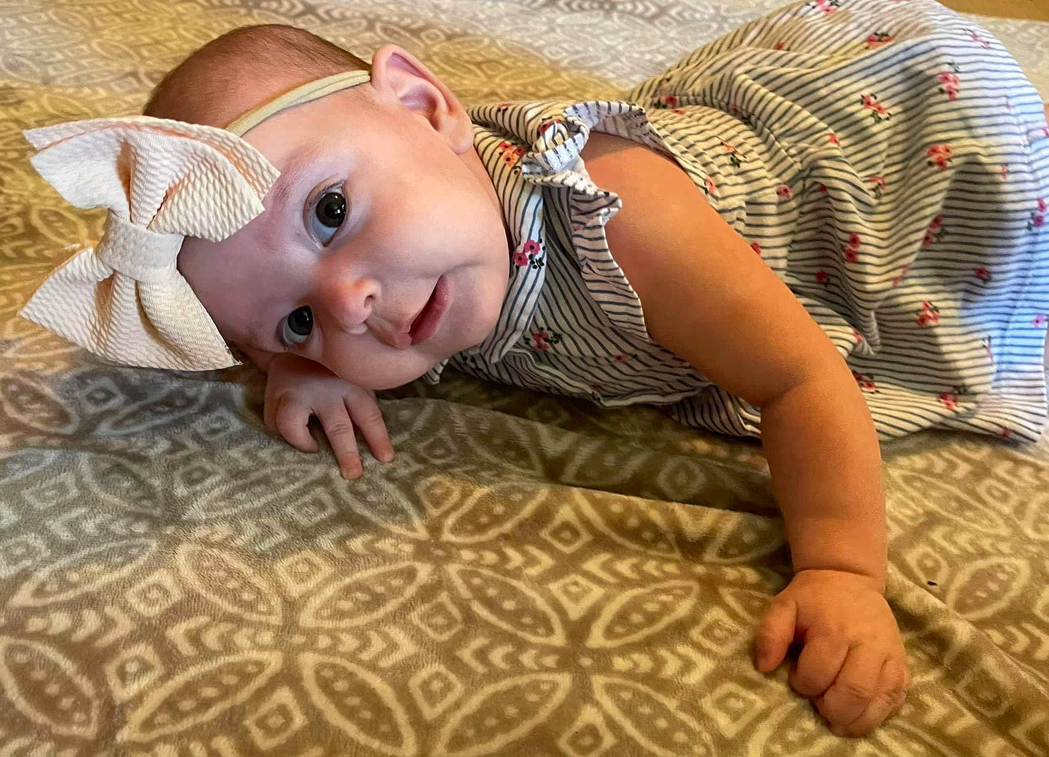 Aubrie is registered to the contest to win money with this photo: baby, baby_toddler_clothing, cheek, comfort, eye, fawn, finger, flash_photography, floor, flooring, grass, happy, hat, headwear, iris, mouth, nose, person, skin, smile