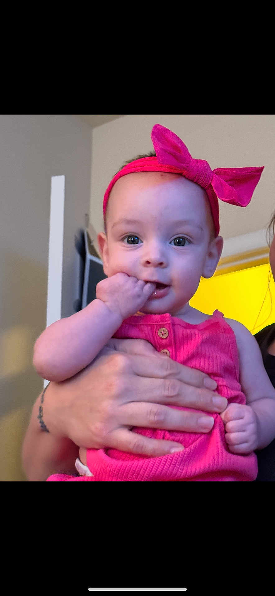 Alora joined the competition — help win amazing prizes! baby, child, infant, pink_headband, bow, pink_outfit, hand, fingers, face, eyes, person, indoor, curious, cute, holding, portrait, skin, expression, human, young