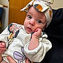 Alora is registered to the contest to win money with this photo: baby, infant, headband, mickey_mouse, minnie_mouse, clothing, hand, person, indoor, door, wall, electrical_outlet, cute, portrait, holding, expression, face, eyes, sleeve, skin