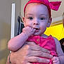 Alora joined the competition — help win amazing prizes! baby, child, infant, headband, pink, hand, fingers, indoor, person, cute, portrait, clothing, holding, face, eyes, skin, young, adorable, expression, human