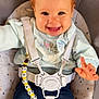baby, child, smiling, happy, face, hair, pony_tail, clothing, sweater, jeans, baby_seat, safety_harness, pacifier, pacifier_clip, indoor, cute, comfort, infant, person, seated