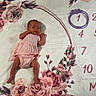 baby, infant, pink_dress, floral_blanket, milestone_blanket, month_marker, newborn, lying_down, flower_pattern, cute, small, portrait, baby_girl, indoor, soft_texture, decorative, fabric, child, one_month, celebration