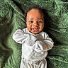 Jaceon is registered to the contest to win money with this photo: baby, infant, child, smiling, happy, portrait, lying_down, white_outfit, onesie, blanket, green_blanket, cozy, indoor, close_up, face, eyes, arms_crossed, happy_expression, soft_texture, photography