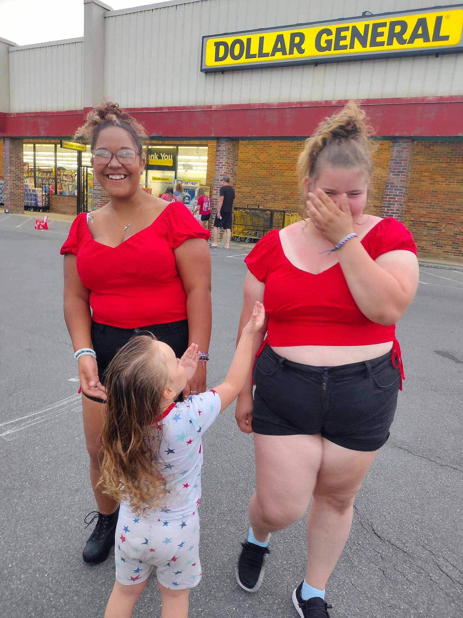 Rose is registered to the contest to win money with this photo: electric_blue, event, eyewear, fun, gesture, happy, human_leg, joy, leg, leisure, luggage_and_bags, person, recreation, red, road, shorts, shoulder, sneakers, t_shirt, thigh