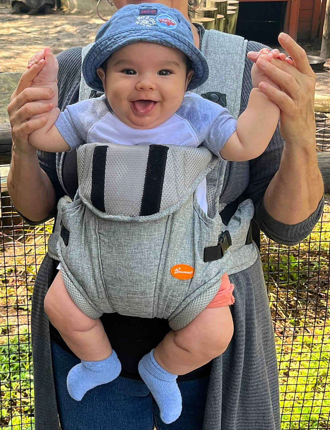 Thayer joined the competition — help win amazing prizes! baby, baby_carriage, baby_toddler_clothing, baseball_cap, cap, face, finger, gesture, grass, happy, head, headwear, joint, person, photograph, plant, skin, sleeve, smile, thumb