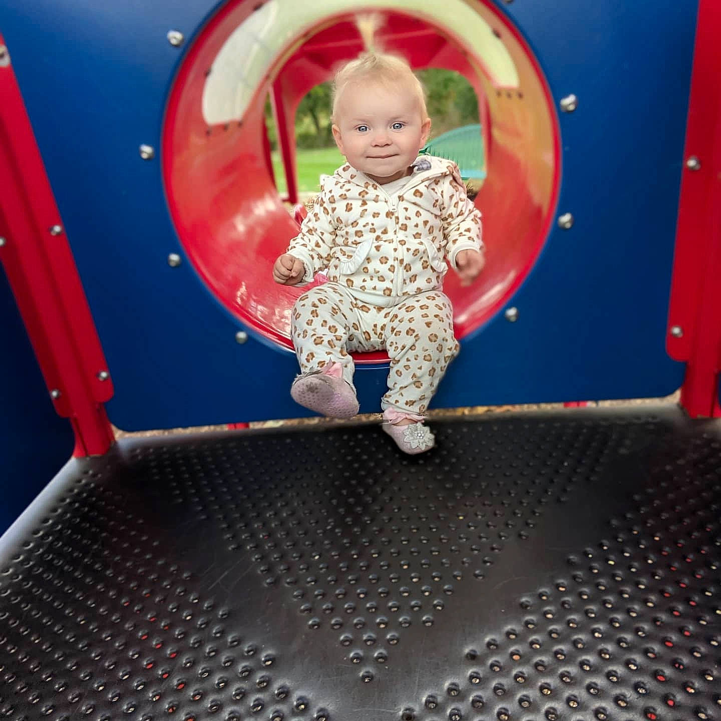 Addison is registered to the contest to win money with this photo: baby, baby_toddler_clothing, child, composite_material, electric_blue, eye, flooring, fun, joy, leisure, magenta, outdoor_play_equipment, person, photograph, play, playground, recreation, red, room, sleeve