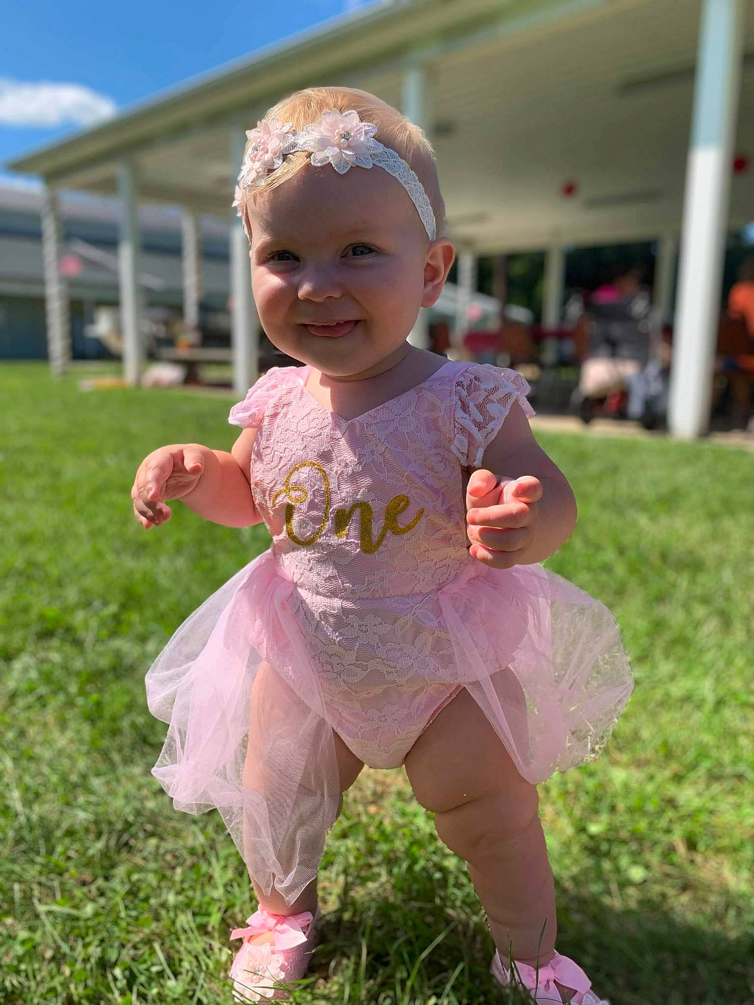 Addison is registered to the contest to win money with this photo: baby, baby_toddler_clothing, child, face, fun, grass, grassland, happy, headwear, joy, leisure, magenta, people_in_nature, person, pink, plant, play, recreation, sandal, sky