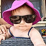 Octavia participe au concours pour gagner de l'argent avec cette photo : accessory, baby, casual, child, closeup, cute, fashion, furniture, hand, infant, outdoor, person, portrait, purple_hat, skin, smile, summer, sunglasses, sunhat, wicker_chair