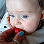 baby, bib, blue_eyes, child, close_up, clothing, curious, cute, face, feeding, fingernail, food, hand, indoor, infant, person, ring, skin, strawberry, yellow_clothing