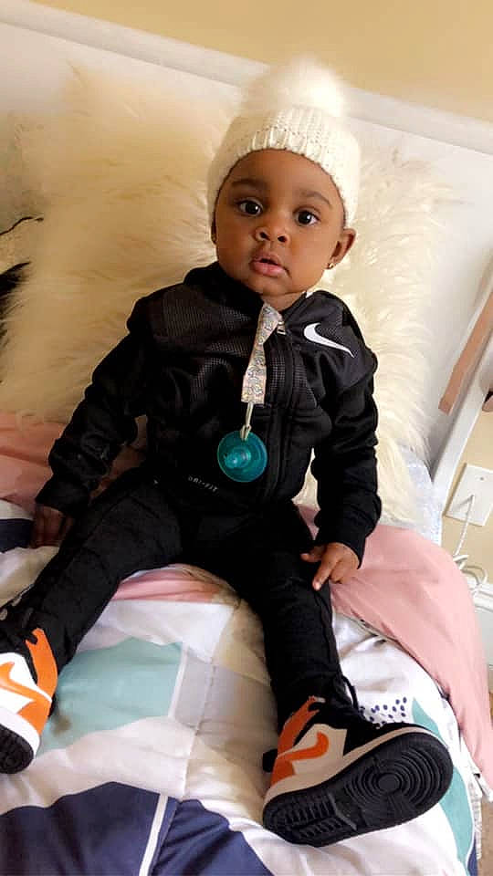 Lailani is registered to the contest to win money with this photo: baby, child, cool, doll, headwear, outerwear, person, sitting, toddler, toy