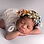 newborn, baby, sleeping, flower_crown, white, soft_texture, infant, peaceful, portrait, cute, resting, skin, hands, head, closed_eyes, fuzzy_wrap, delicate, adorable, young_child, calm