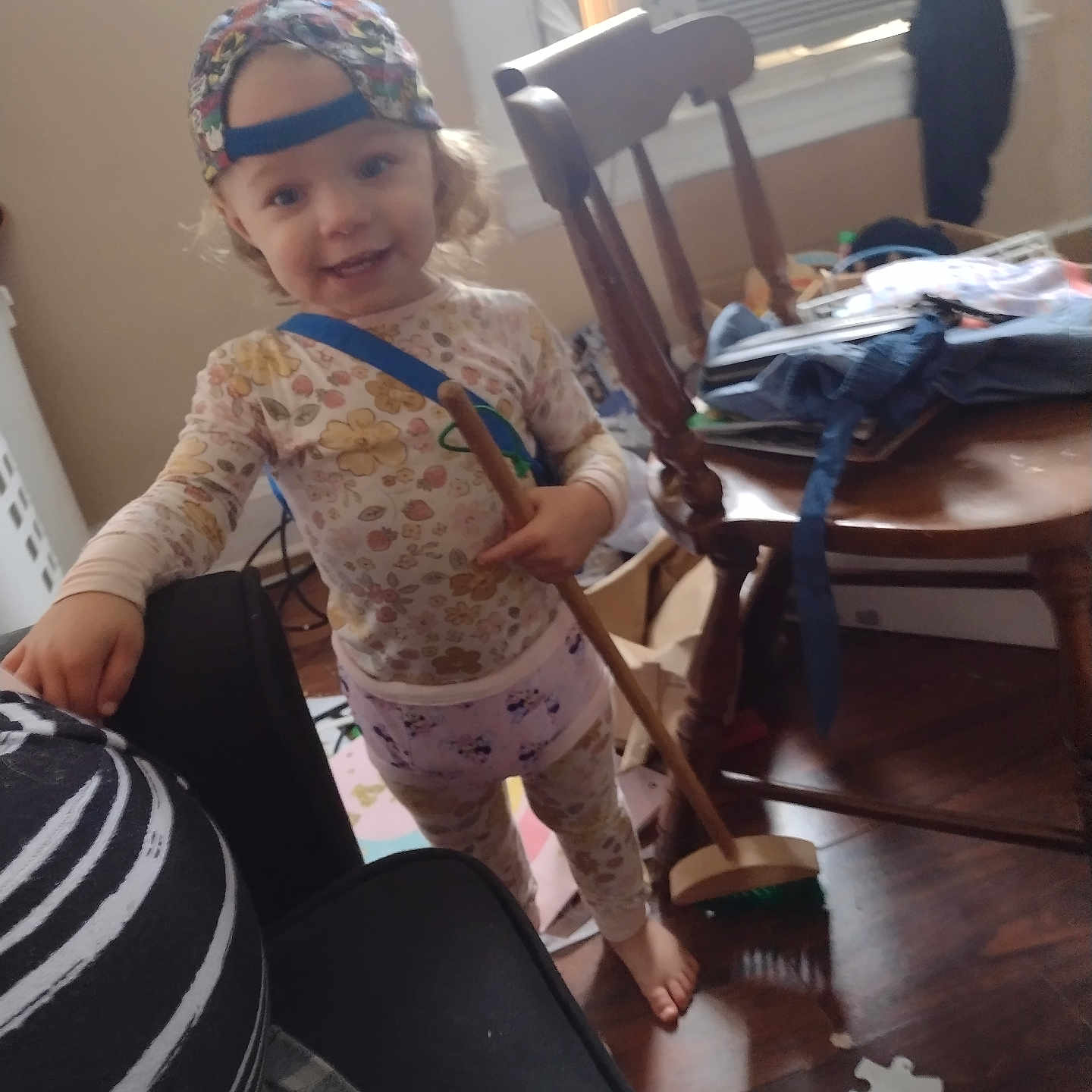 Layla is registered to the contest to win money with this photo: adult, architecture, baby, bonnet, building, cap, chair, clothing, face, furniture, hardwood, hat, head, indoors, livingroom, male, man, person, room, wood