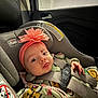 baby, infant, car_seat, seatbelt, buckle, headband, flower_headband, pacifier_clip, window, raindrops, car_interior, smile, cute, clothing, cozy, safety_label, rear_facing, closeup, chubby_cheeks, brand_chicco