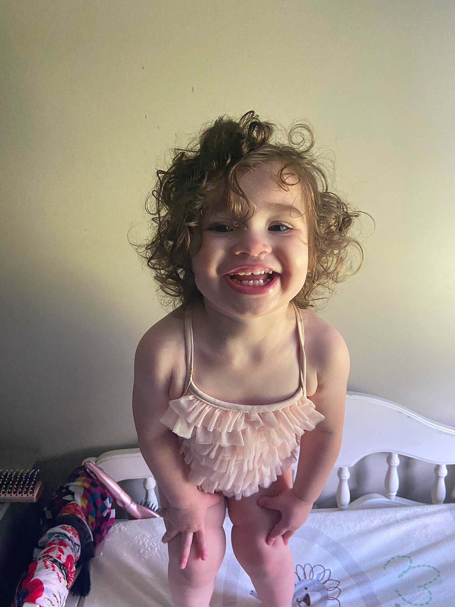 Charliegh is registered to the contest to win money with this photo: baby_toddler_clothing, bed, blond, brown_hair, child, flash_photography, fun, hair, happy, human_leg, iris, joy, laugh, long_hair, person, pillow, portrait_photography, room, sitting, skin