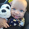 baby, child, blue_eyes, tongue_out, stuffed_animal, panda, plush_toy, car_seat, infant, cute, smiling, hand, clothing, patterned, close_up, portrait, indoor, seatbelt, soft_toy, happy