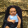 Kingston is registered to the contest to win money with this photo: baby, child, infant, blue_eyes, smile, babybjorn, carrier, outdoor, forest_floor, rocks, sunlight, white_clothing, cute, happy, portrait, seated, nature, small_hands, toddler, daylight