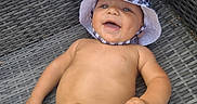 Kingston joined the competition — help win amazing prizes! baby, child, smiling, hat, checkered, toy, hand, wicker_chair, outdoor, happy, skin, closeup, person, infant, cute, summer, relaxed, lying_down, playful, bright