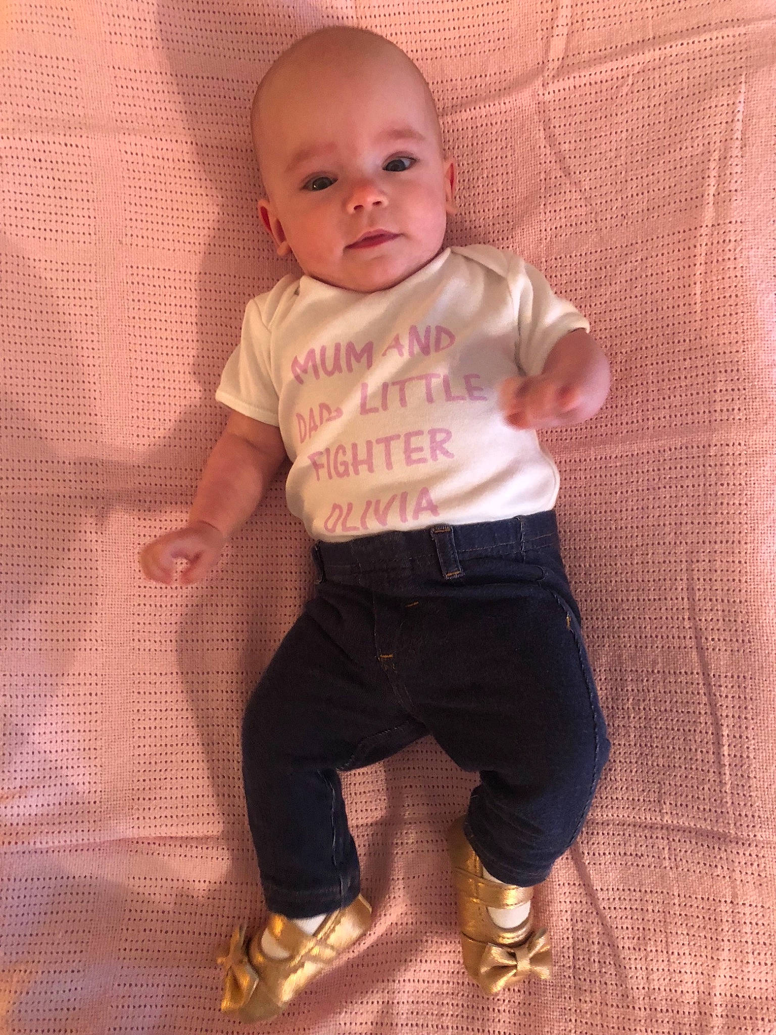 Olivia Rose is registered to the contest to win money with this photo: arm, baby, baby_toddler_clothing, child, person, pink, skin, sleeve, smile, standing, t_shirt, toddler