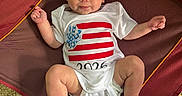 Kaisyn joined the competition — help win amazing prizes! baby, blue_eyes, child, cute, expression, ground, handprint, head, infant, legs, looking_up, onesie, outdoor, person, red_chair, rocks, sitting, skin, small_legs, white_clothing