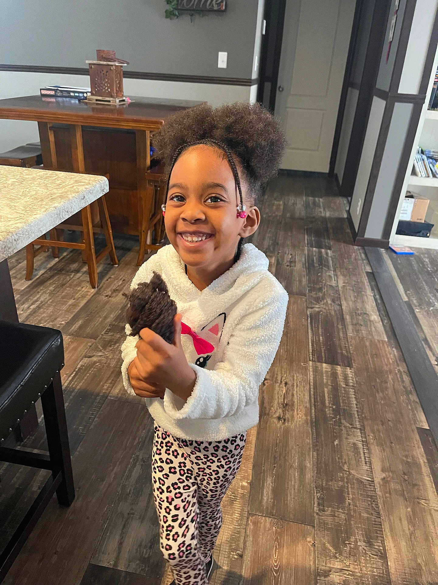 Keyonna is registered to the contest to win money with this photo: bodypart, child, diningtable, face, female, finger, furniture, girl, hand, happy, hardwood, head, indoors, interiordesign, person, photography, portrait, smile, table, wood