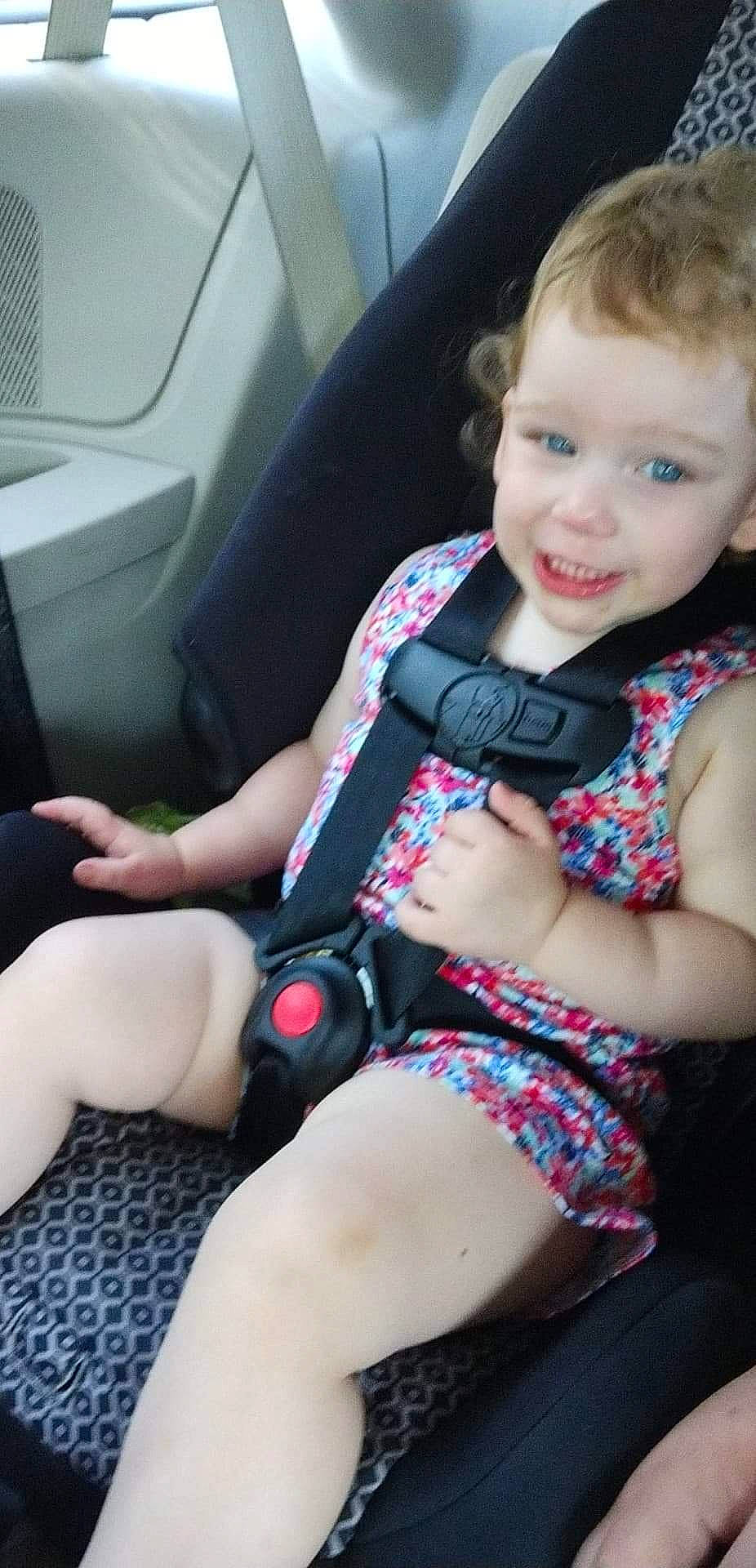Athena joined the competition — help win amazing prizes! auto_part, automotive_design, baby_toddler_clothing, car_seat, car_seat_cover, clothing, comfort, dress, finger, head_restraint, joint, knee, leg, person, seat_belt, smile, steering_part, steering_wheel, thigh, toddler