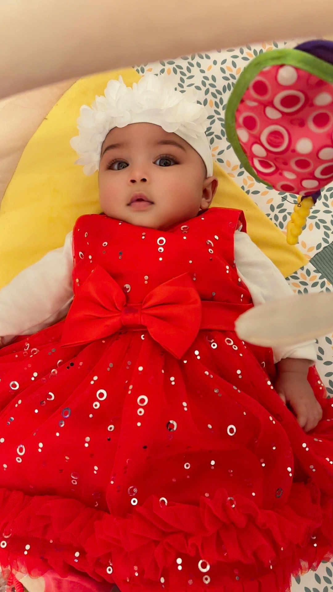 Maylana a rejoint le concours — aidez-le/la à gagner de superbes lots ! baby, child, red_dress, headband, flower, bow, sparkles, blanket, pattern, toy, infant, cute, lying_down, indoors, soft_toy, colorful, face, person, young_child, closeup