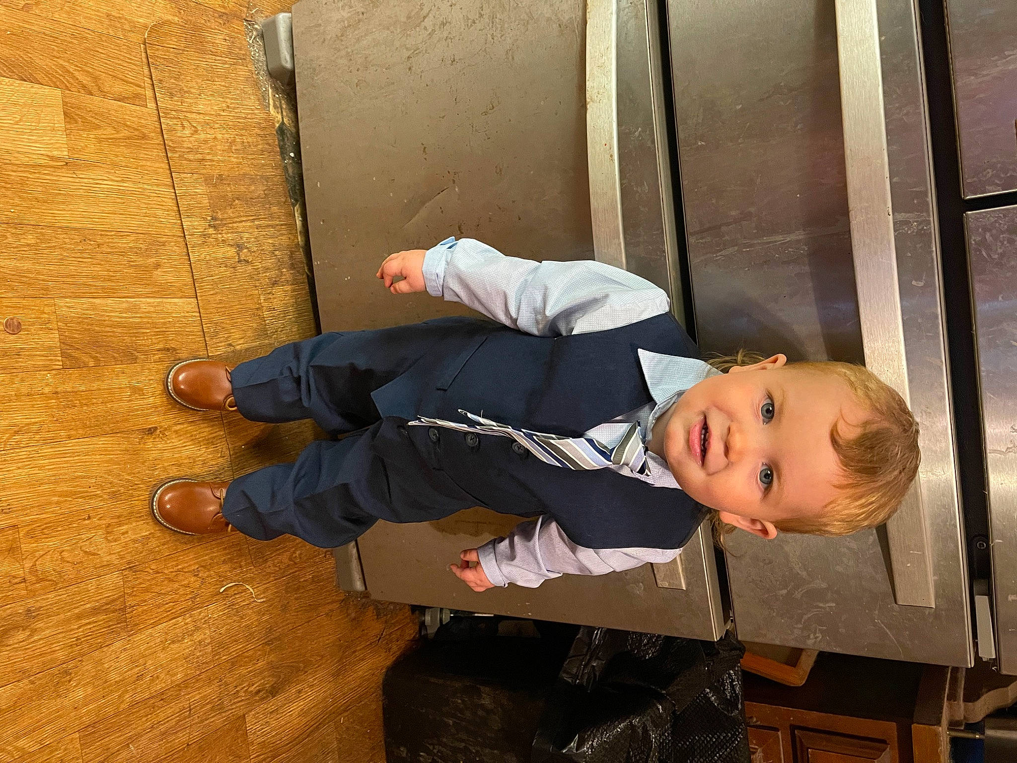Kaiden joined the competition — help win amazing prizes! baby, baby_toddler_clothing, child, door, flooring, happy, hardwood, outdoor_shoe, person, sitting, sleeve, smile, suit, toddler, varnish, walking_shoe, wood, wood_flooring, wood_stain