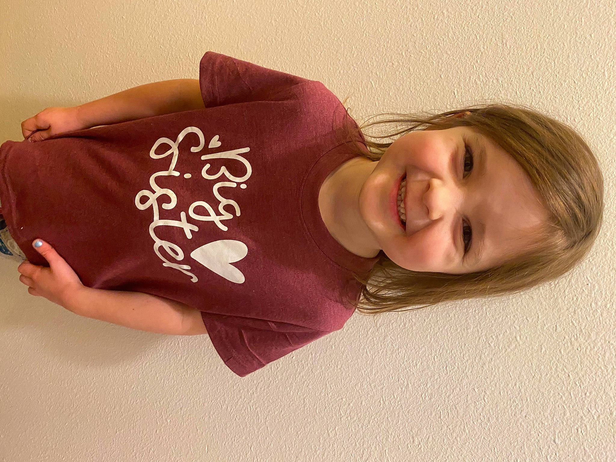 Morgan is registered to the contest to win money with this photo: abdomen, baby_toddler_clothing, chest, child, elbow, eye, face, fashion_accessory, happy, human_leg, joy, knee, lip, magenta, person, skin, sleeve, smile, t_shirt, thigh