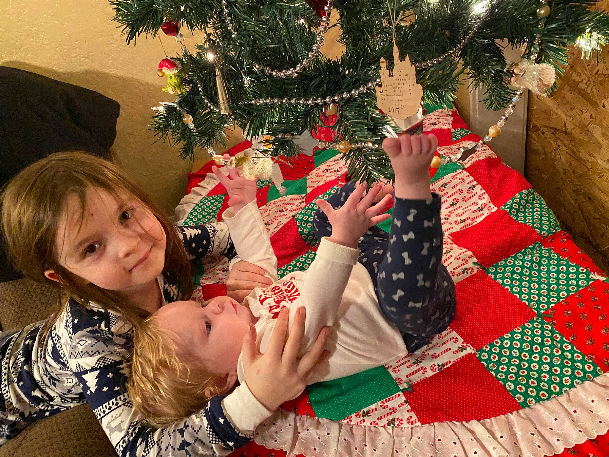 Morgan joined the competition — help win amazing prizes! baby, christmas, christmas_decoration, christmas_eve, christmas_ornament, christmas_tree, conifer, event, fun, happy, holiday, holiday_ornament, interior_design, lap, ornament, pattern, person, sitting, smile, toddler