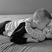 Alessandro participe au concours pour gagner de l'argent avec cette photo : black_and_white, baby, bed, brother, child, clothing, cuddle, family, gentle, hug, infant, kiss, laying_down, love, monochrome, older_child, portrait, sibling, smile, toddler