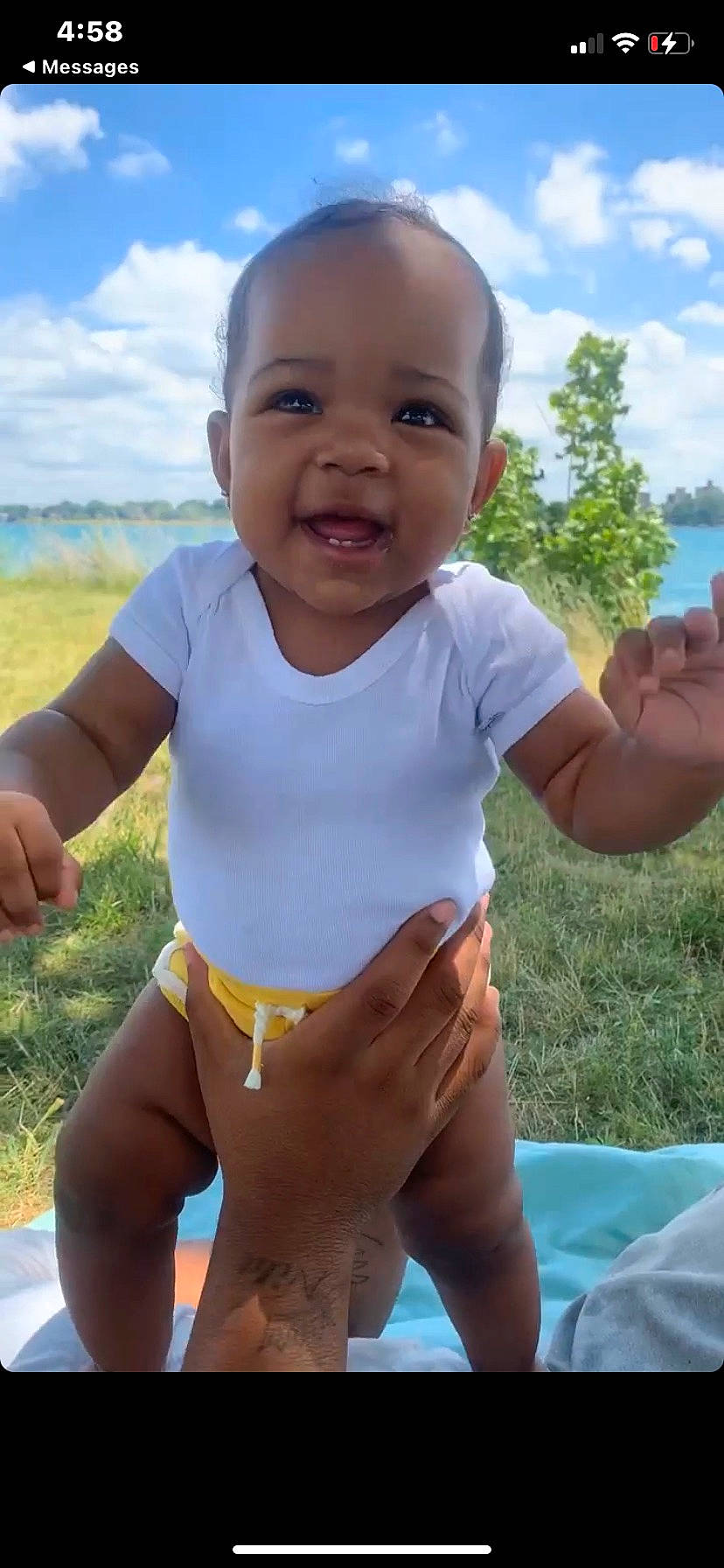 Rylee is registered to the contest to win money with this photo: baby_toddler_clothing, child, cloud, facial_expression, finger, fun, gesture, grass, hand, happy, muscle, people_in_nature, person, photograph, skin, sky, sleeve, smile, summer, thumb