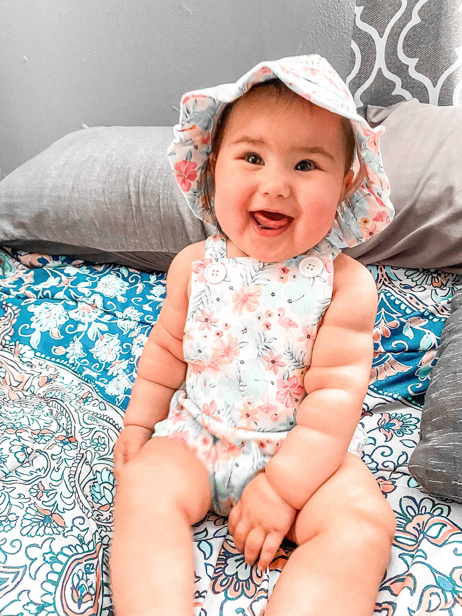 Julianna is registered to the contest to win money with this photo: aqua, baby, baby_toddler_clothing, child, comfort, eye, fashion_accessory, fun, happy, headwear, human_leg, iris, linens, pattern, person, pink, product, skin, sleeve, smile