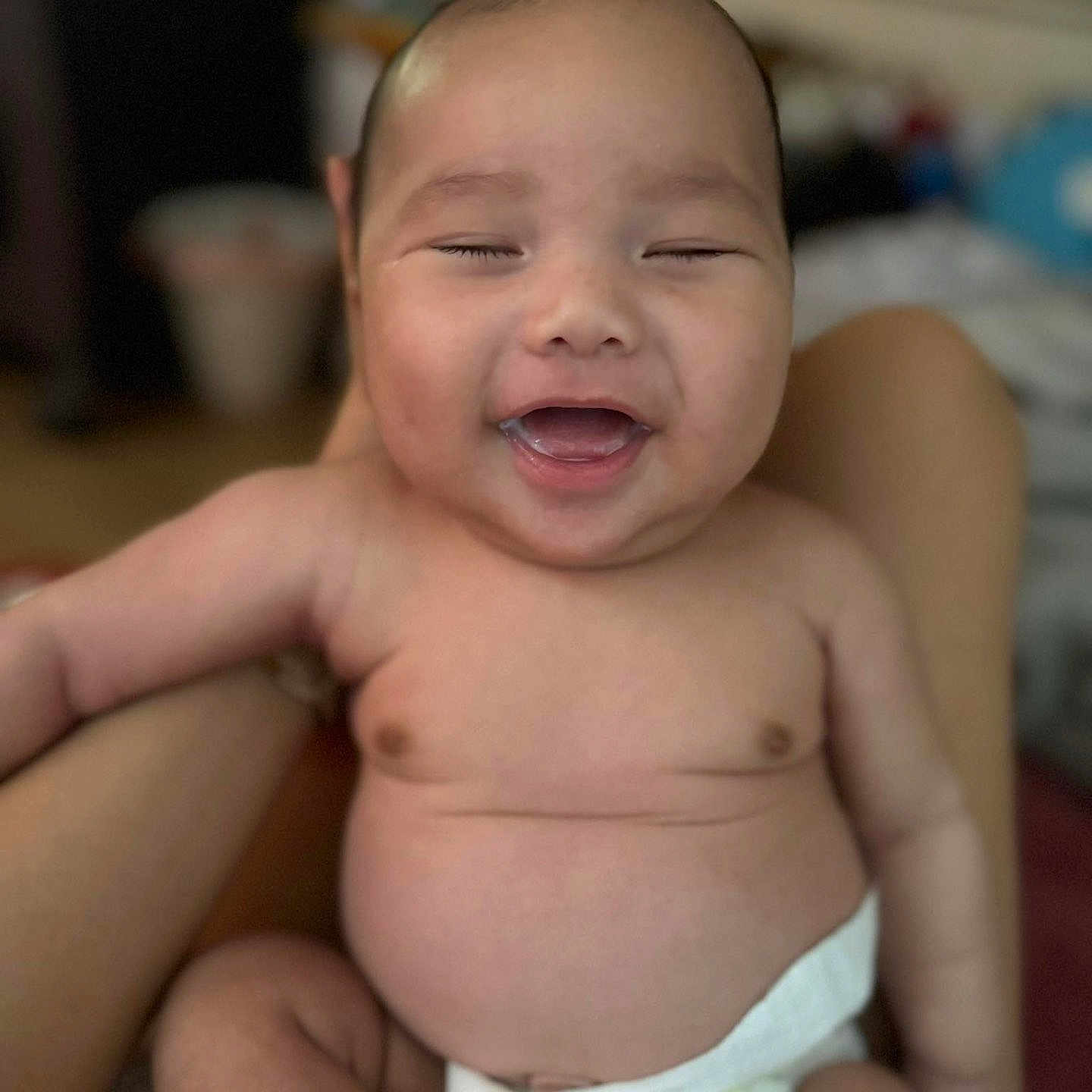 Adharie joined the competition — help win amazing prizes! arm, baby, blurred_background, child, closeup, cute, diaper, expression, face, happy, human, indoors, infant, joy, newborn, person, portrait, sitting, skin, smiling