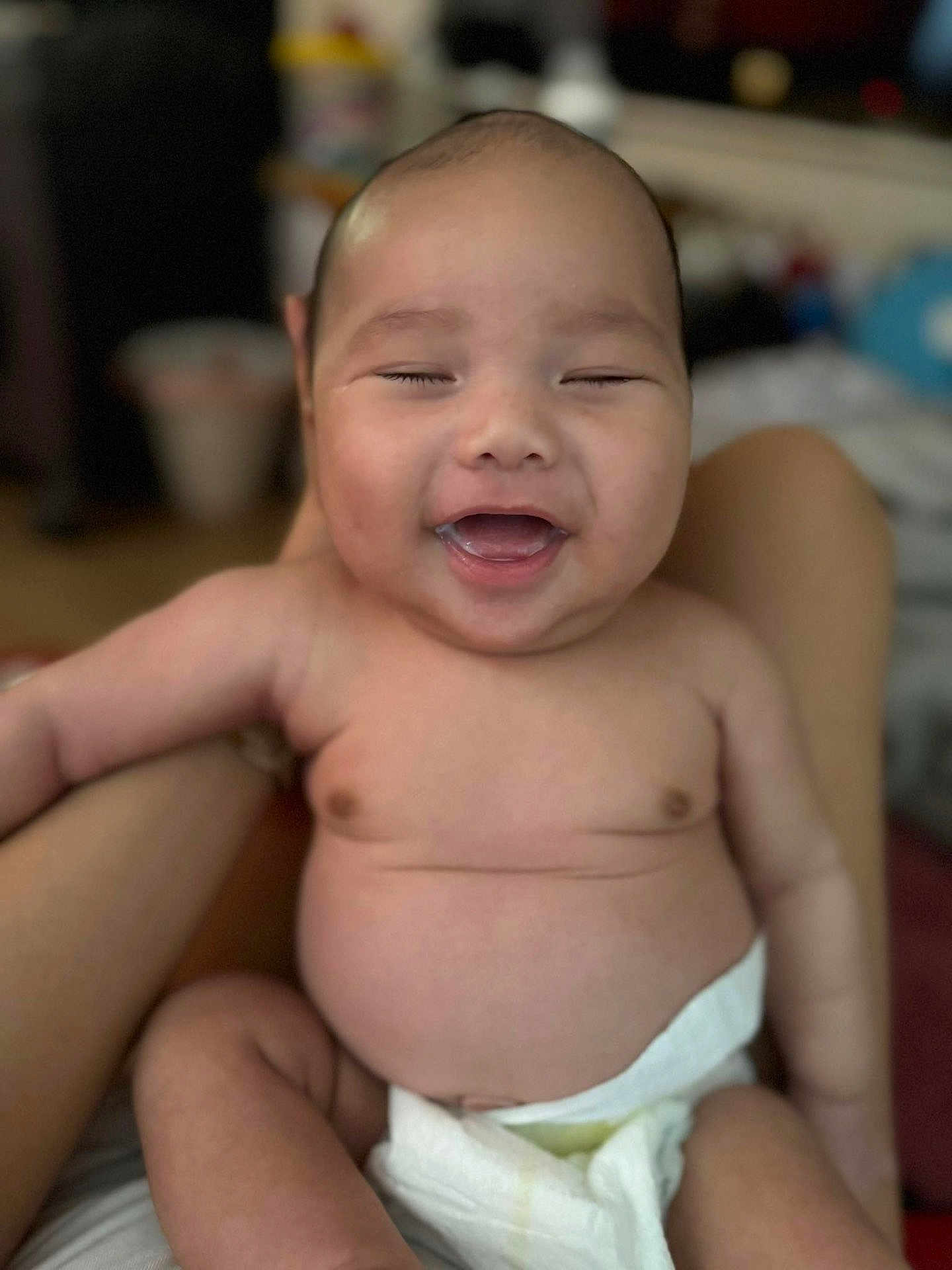 Adharie joined the competition — help win amazing prizes! baby, smiling, diaper, child, happy, skin, face, person, infant, cute, arm, sitting, indoors, blurred_background, expression, joy, closeup, human, newborn, portrait