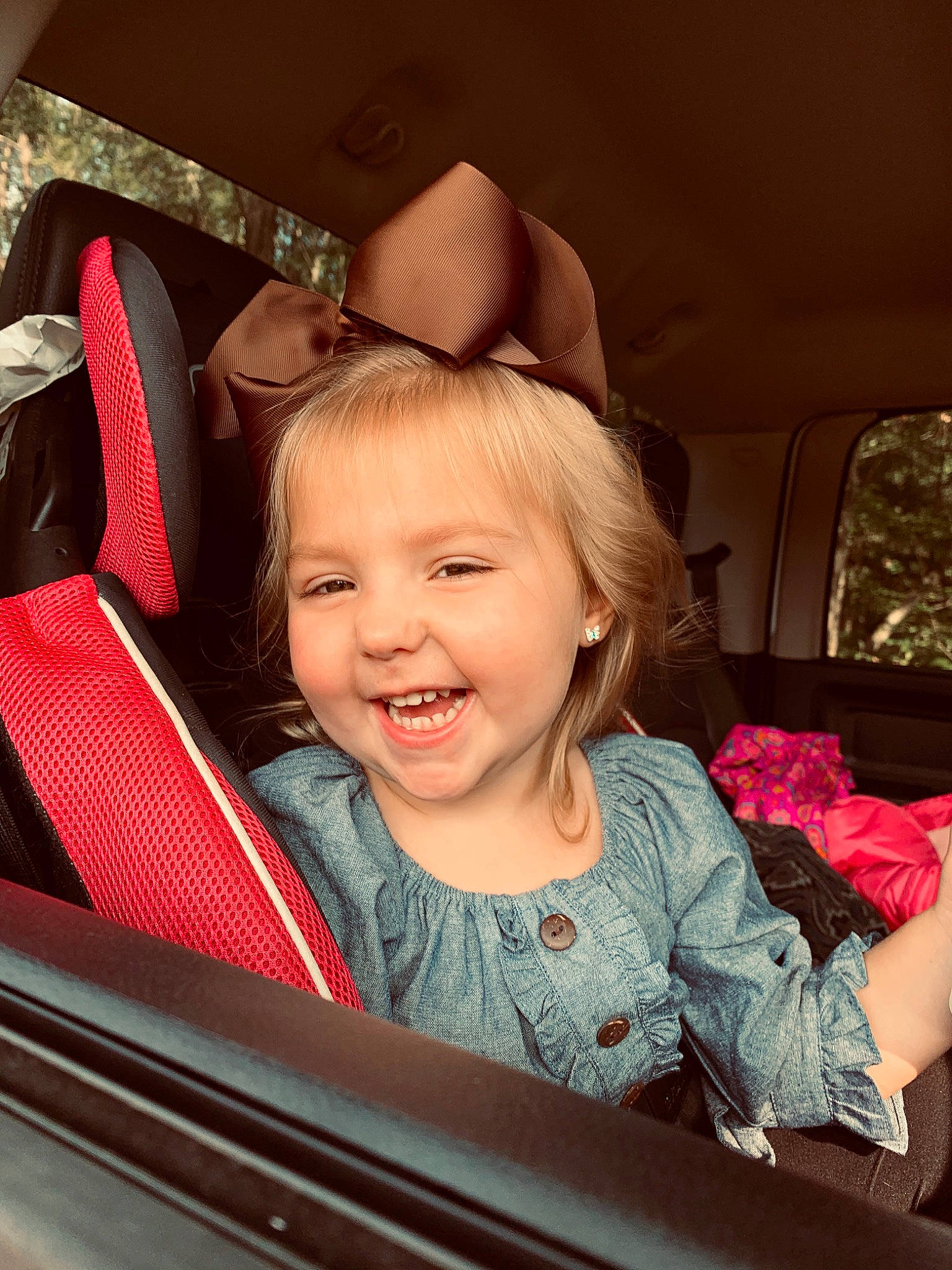 Maisyn is registered to the contest to win money with this photo: baby, cheek, child, ear, eye, face, facial_expression, fun, happy, head, human_body, joy, laugh, organ, people, person, pink, sitting, skin, smile