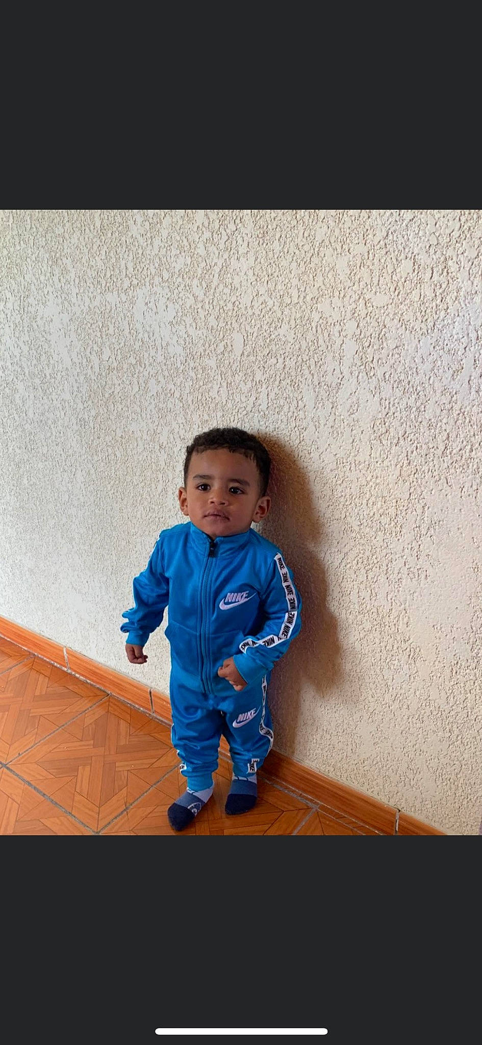 Gio is registered to the contest to win money with this photo: baby, blue, child, outerwear, person, photography, smile, standing, toddler